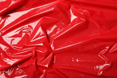 Photo of Red plastic stretch wrap as background, top view