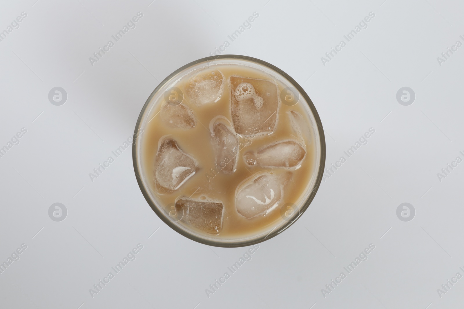 Photo of Iced coffee in glass on white background, top view