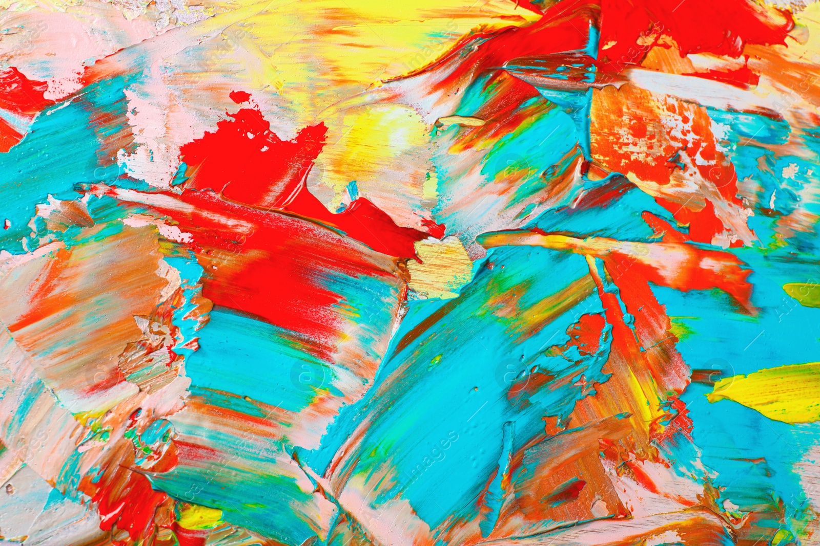 Photo of Closeup view of artist's palette with mixed bright paints as background