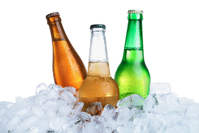 Photo of Ice cubes and different bottles on white background