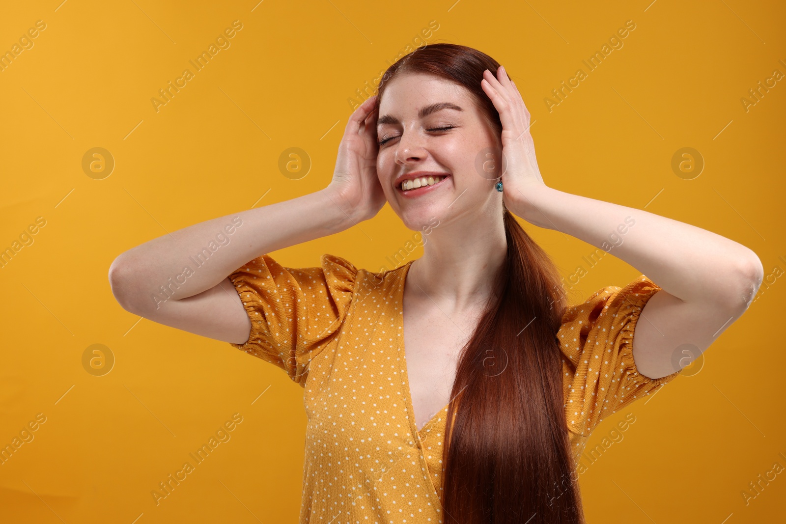 Photo of Portrait of smiling woman on yellow background