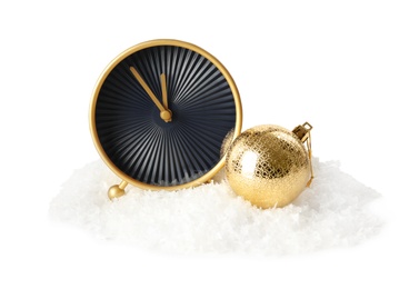 Photo of Alarm clock and Christmas ball in pile of snow on white background. New Year countdown