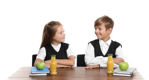 Photo of Happy children with healthy food for school lunch at desk on white background