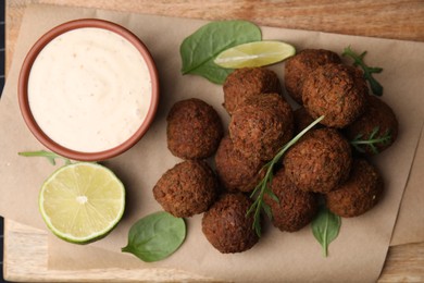 Photo of Delicious falafel balls served on wooden table, top view