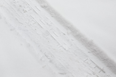Photo of Car tire track on fresh snow, outdoors
