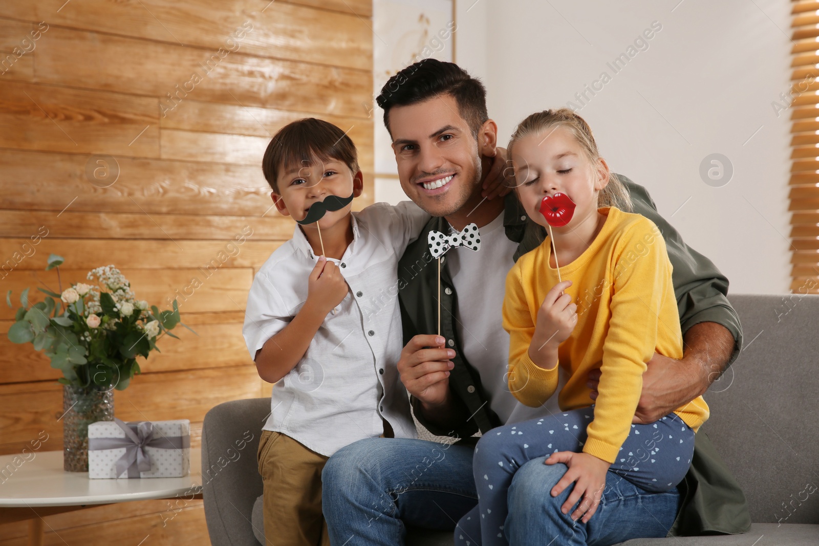 Photo of Dad and his children having fun at home. Happy Father's Day