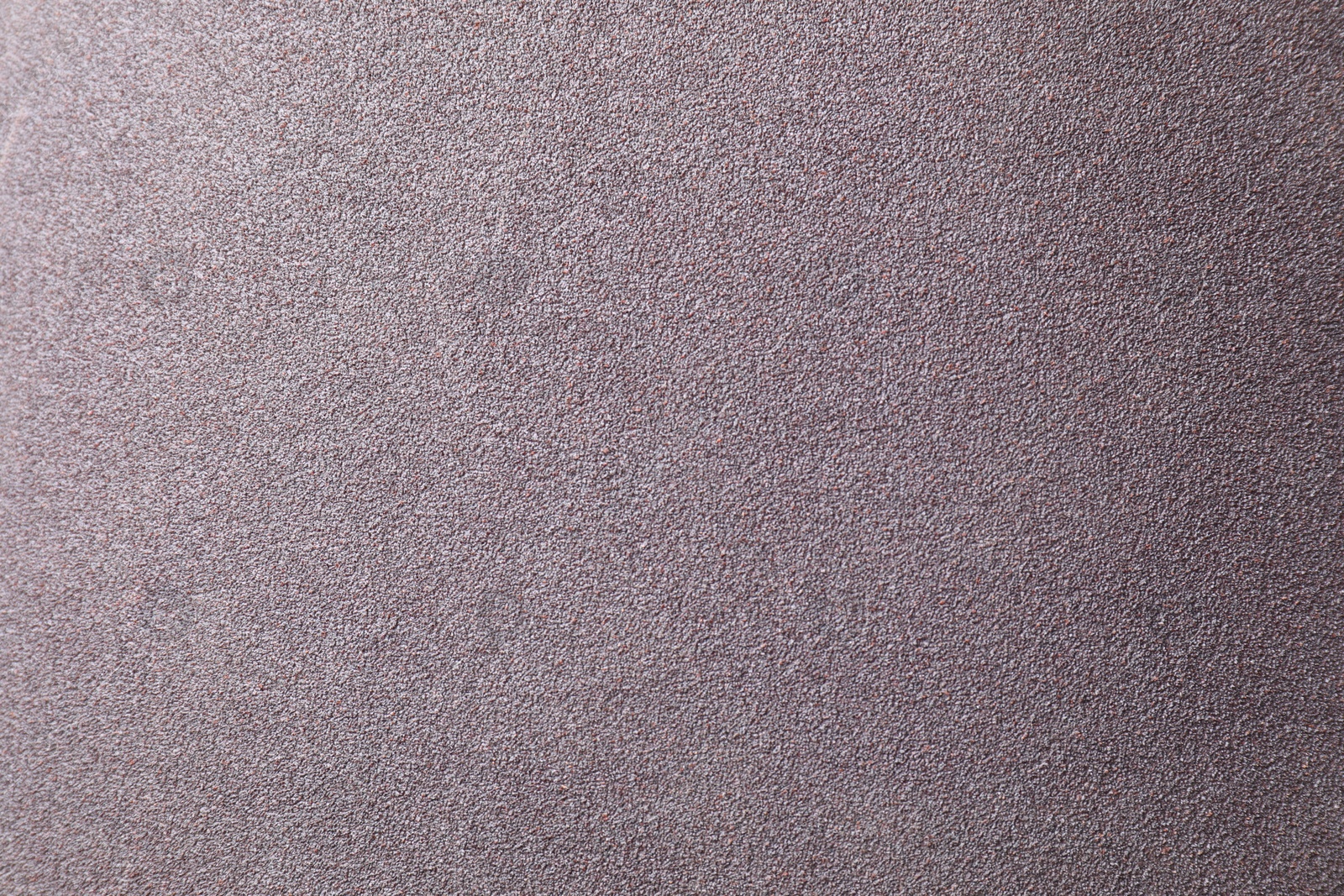 Photo of Texture of coarse sandpaper as background, top view