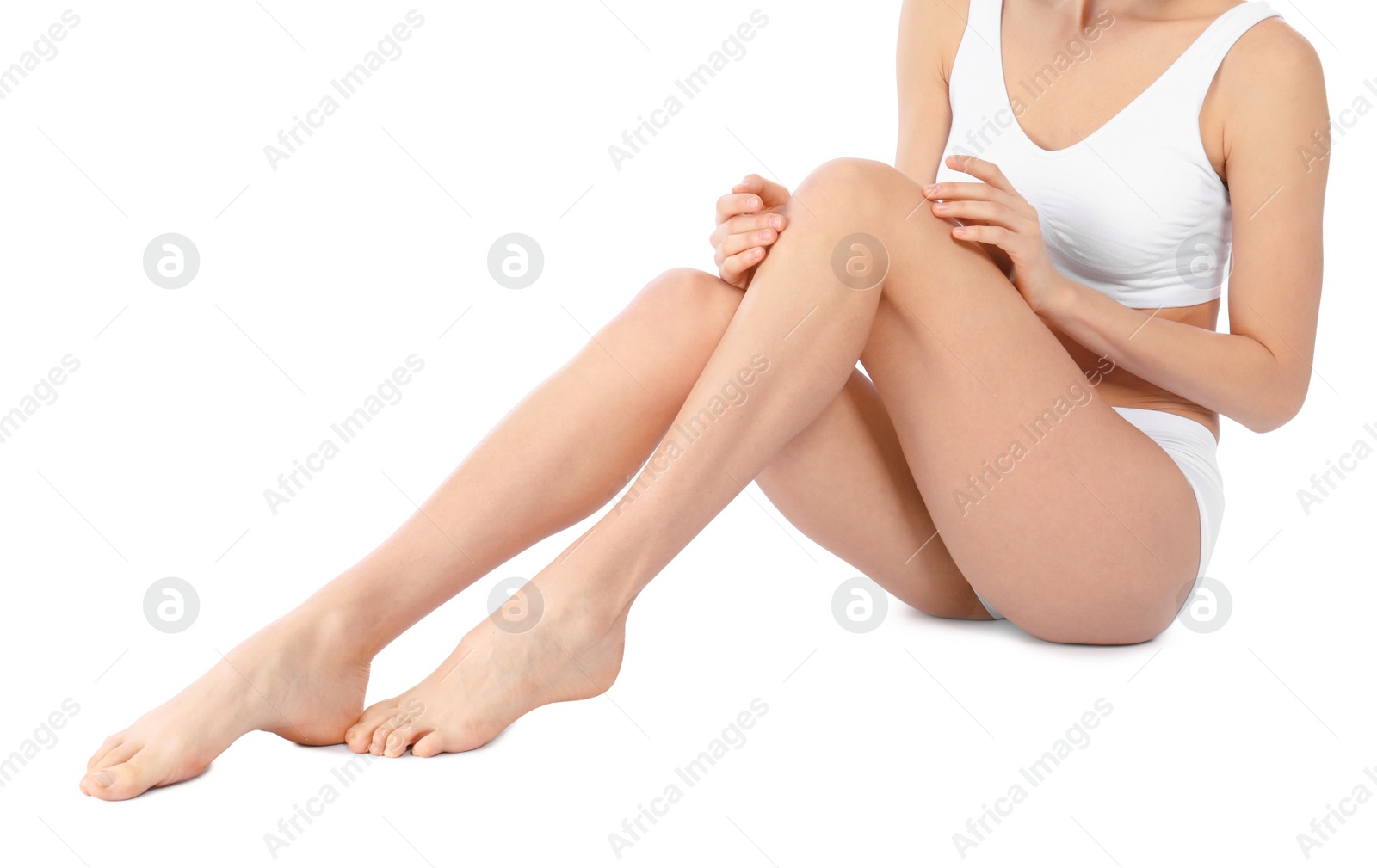 Photo of Young woman with perfect smooth skin on white background, closeup of legs. Beauty and body care