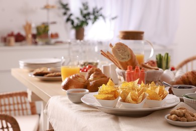 Photo of Dishes with different food on table in room. Luxury brunch