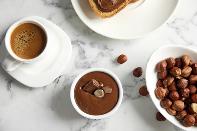 Photo of Sweet chocolate mousse with coffee served on marble table, flat lay