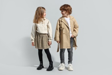 Fashion concept. Stylish children posing on light grey background