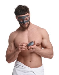 Photo of Handsome man with clay mask on his face against white background