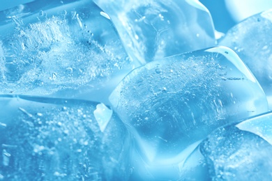 Photo of Transparent ice cubes as background, closeup view