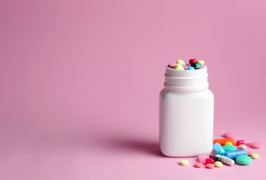 Bottle with pills on color background