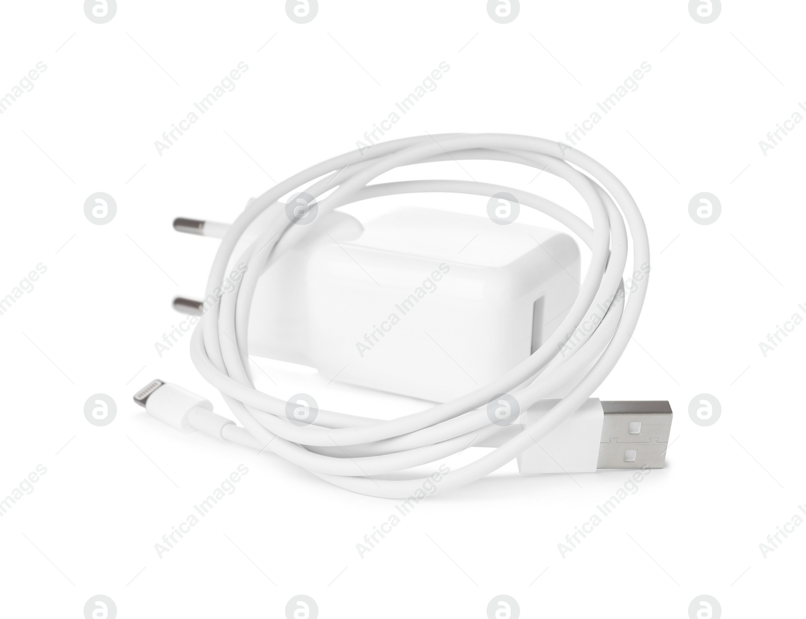 Photo of USB charge cable and power adapter on white background. Modern technology