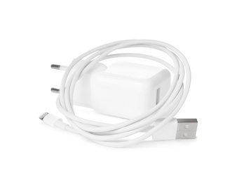 Photo of USB charge cable and power adapter on white background. Modern technology