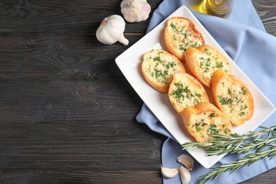 Flat lay composition with tasty garlic bread and space for text on table