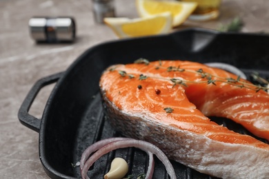 Photo of Frying pan with fresh raw salmon steak, closeup