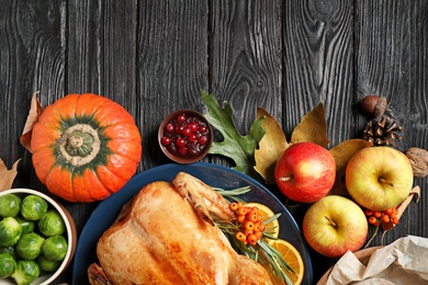 Photo of Flat lay composition with turkey on dark wooden background. Happy Thanksgiving day