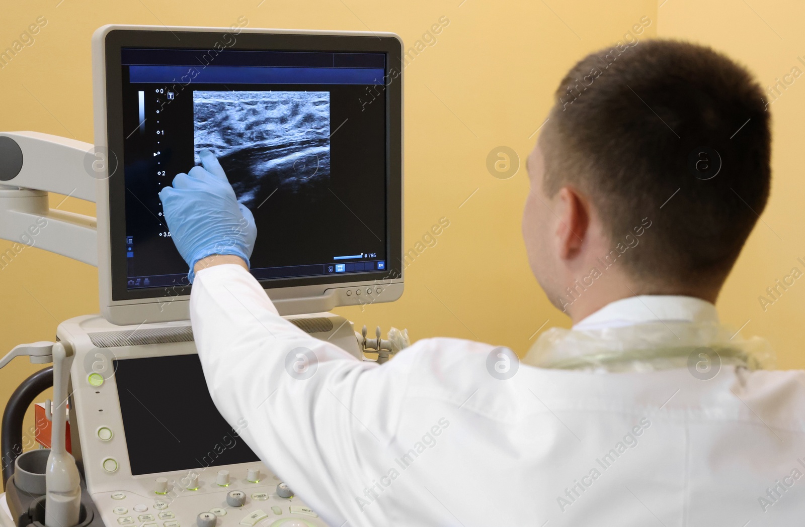 Photo of Mammologist working with ultrasound machine in clinic