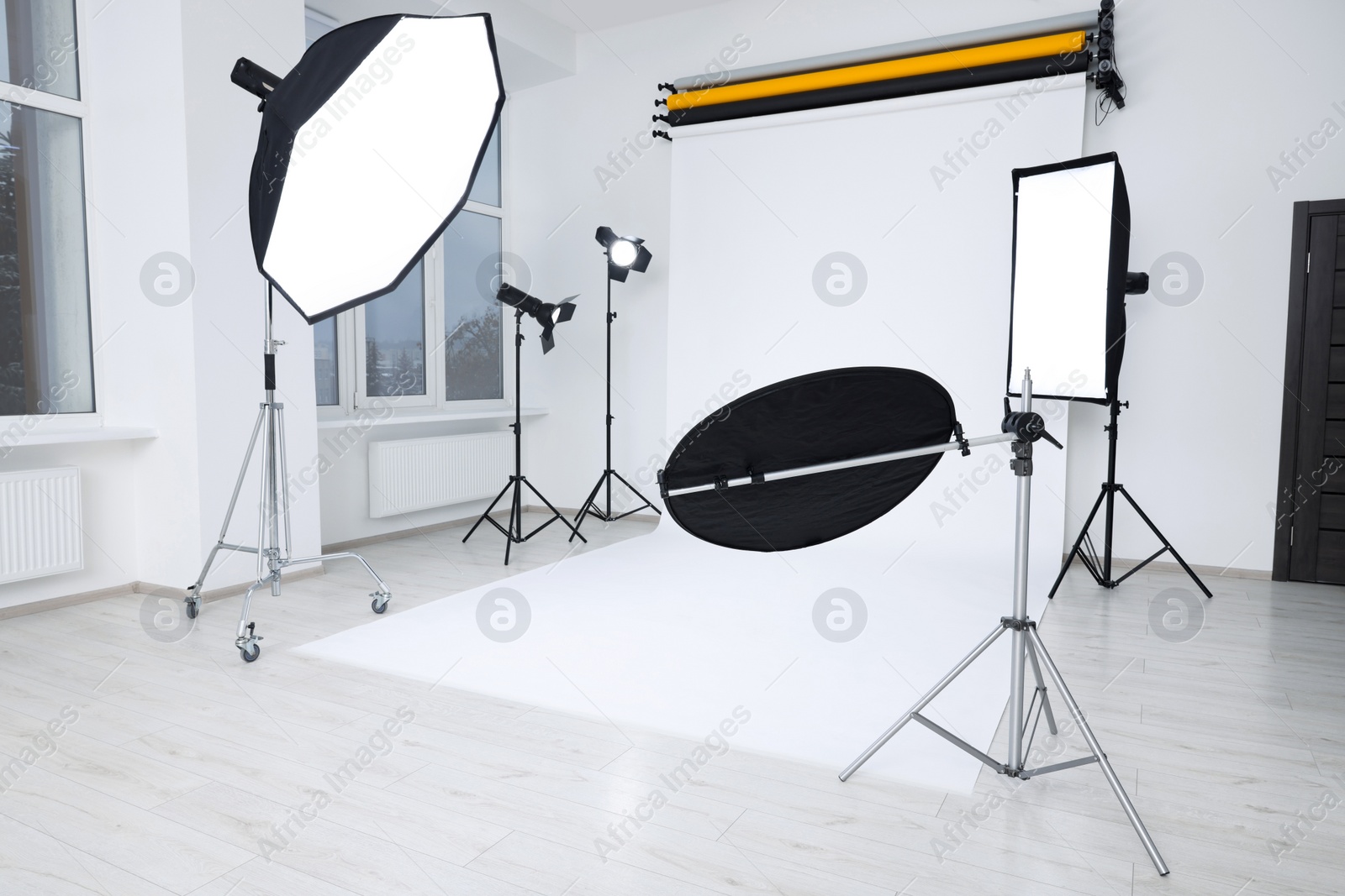 Photo of Interior of modern photo studio with professional lighting equipment