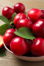 Photo of Fresh ripe cherry plums on wooden table, closeup