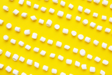 Photo of Delicious marshmallows on yellow background, flat lay