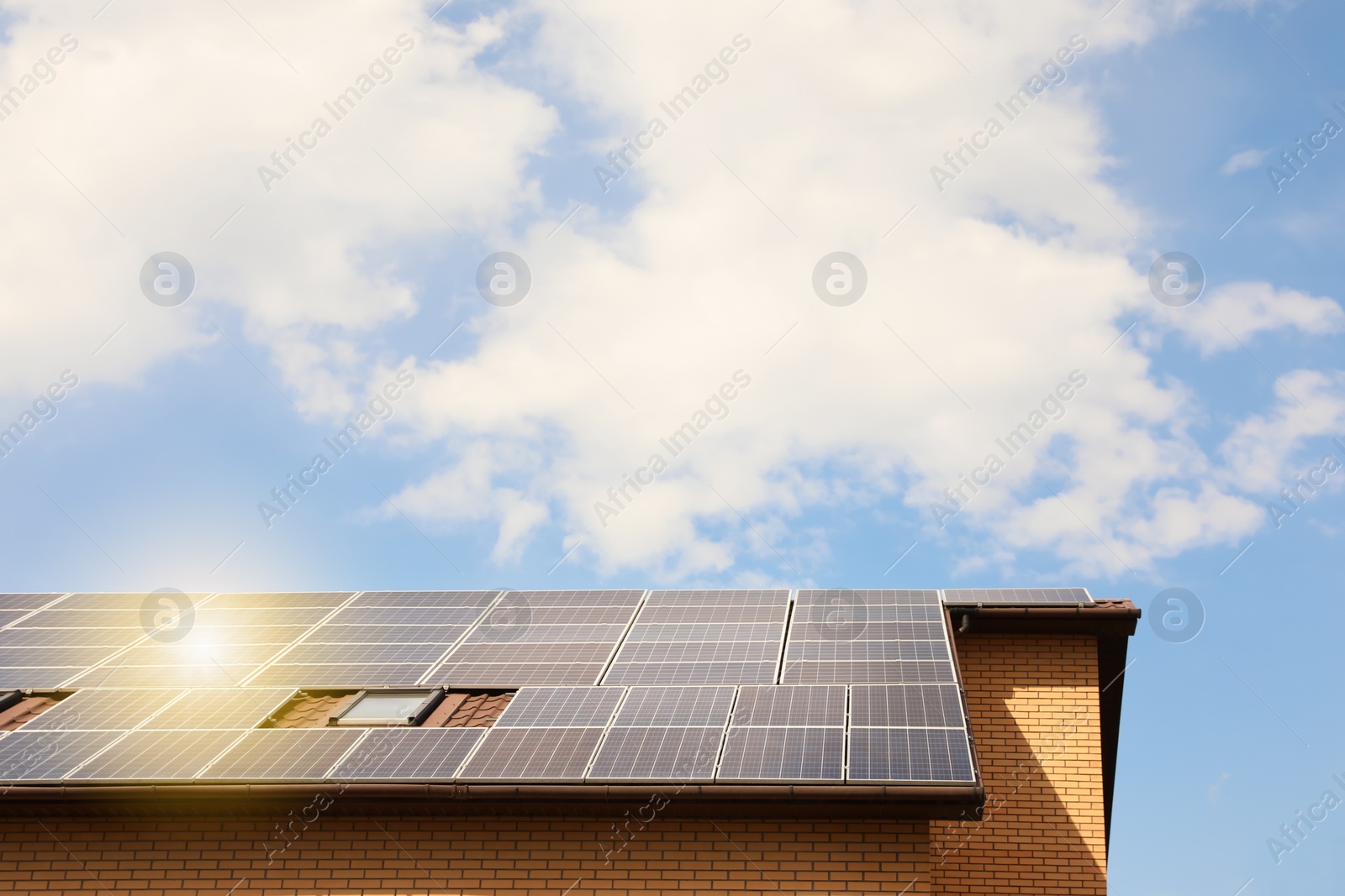 Photo of Building with installed solar panels on roof. Alternative energy source