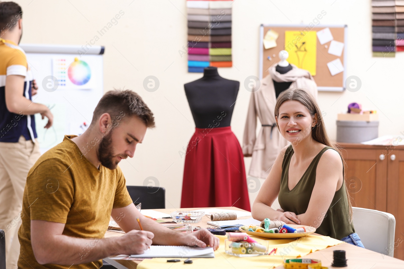 Photo of Fashion designers creating new clothes in studio