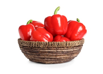 Photo of Wicker bowl with tasty bell peppers on white background