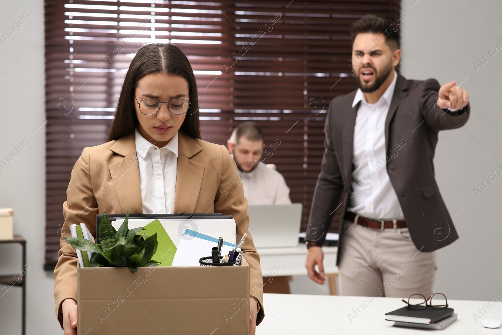 Photo of Boss dismissing young woman from work in office