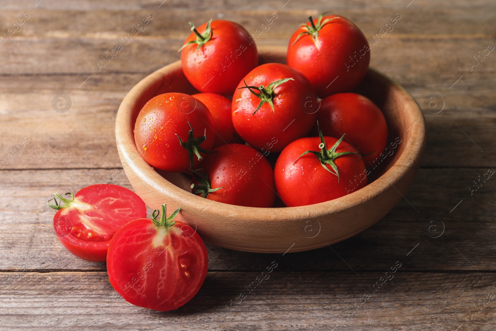 Photo of Fresh ripe red tomatoes on wooden table