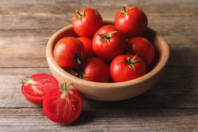 Photo of Fresh ripe red tomatoes on wooden table