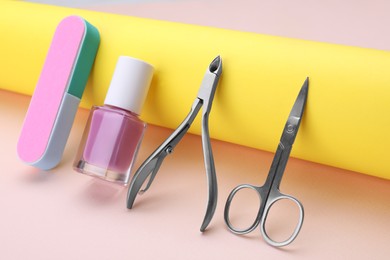 Photo of Set of pedicure tools on beige background