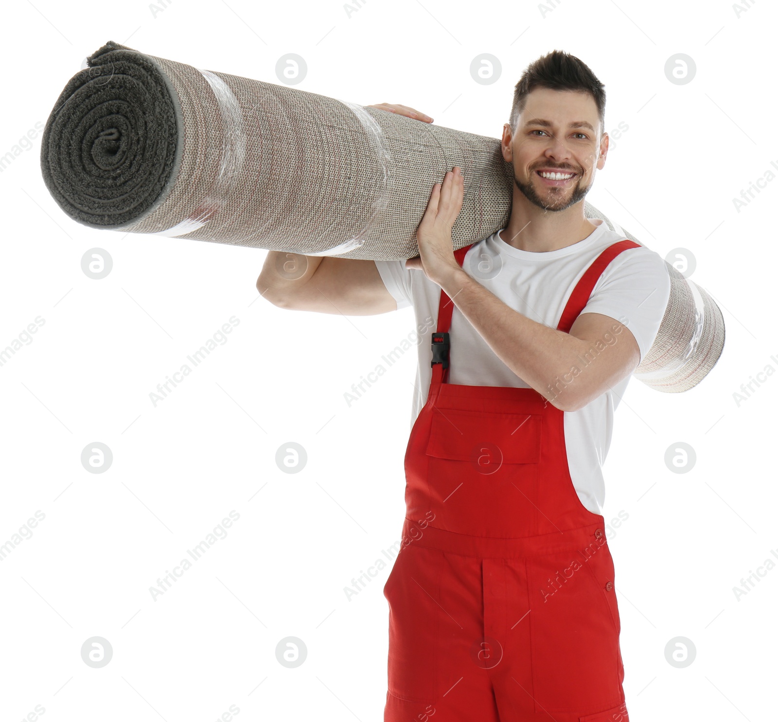 Photo of Male worker with rolled carpet on white background