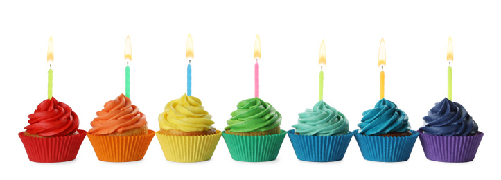 Photo of Delicious birthday cupcakes with candles isolated on white