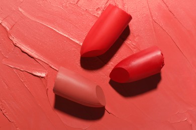 Photo of Different beautiful lipsticks as background, top view