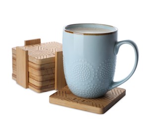 Photo of Mug of coffee and stylish wooden cup coasters on white background