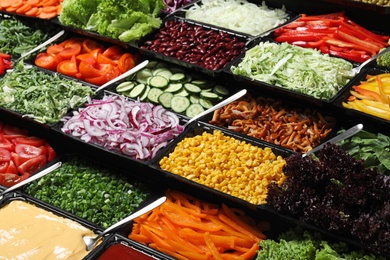 Photo of Salad bar with different fresh ingredients as background