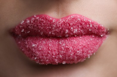 Photo of Young woman with beautiful lips covered in sugar, closeup