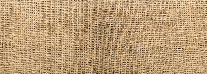 Image of Texture of natural burlap fabric as background, top view. Banner design