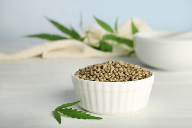 Ceramic bowl with hemp seeds on table