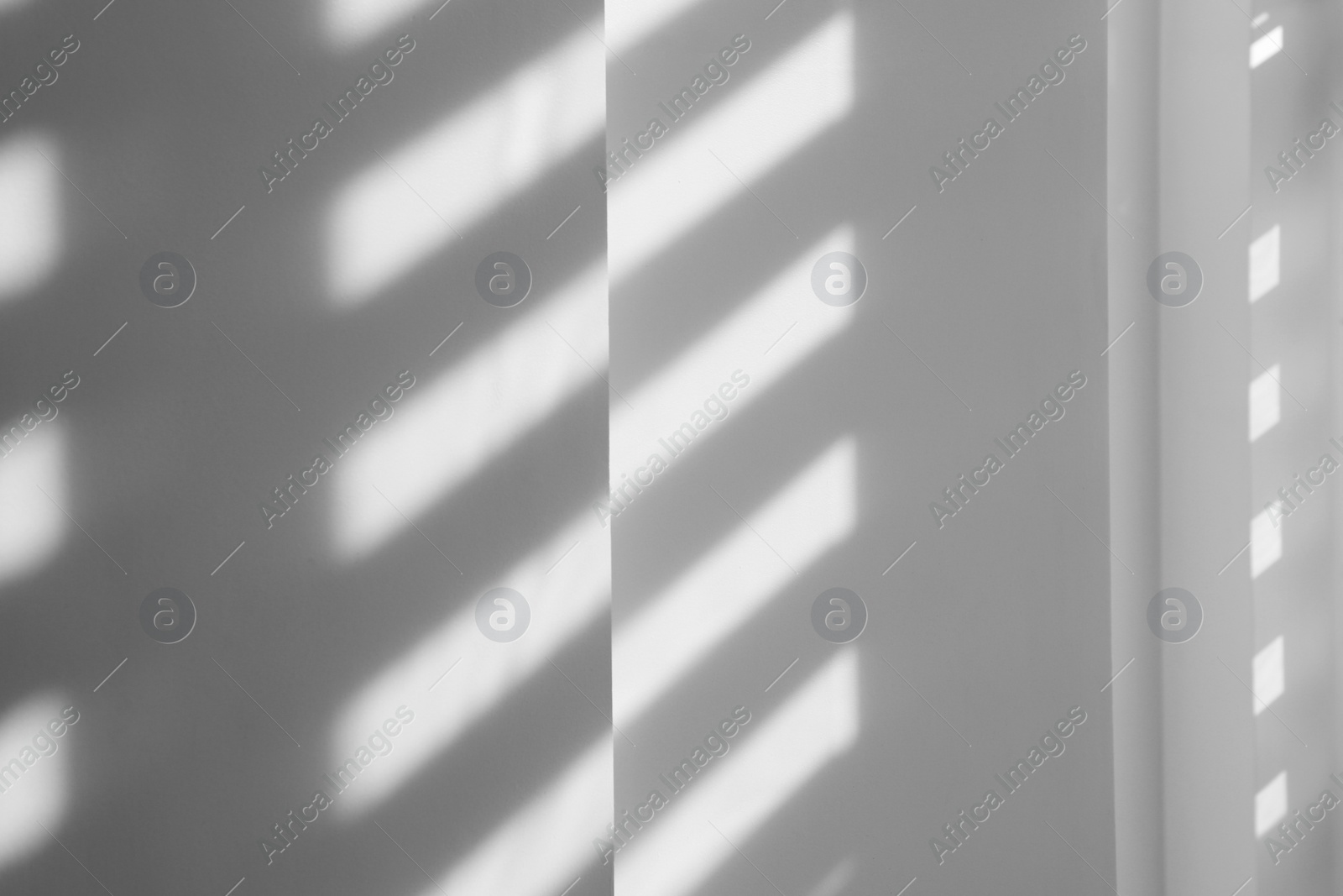 Photo of Lines made of light and shadows on white wall