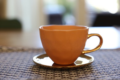 Photo of Cup of hot drink on table indoors, closeup