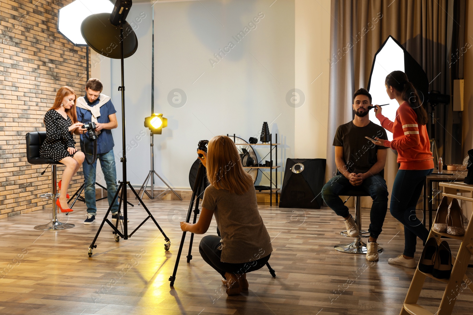 Photo of Photo studio with professional equipment and team of workers