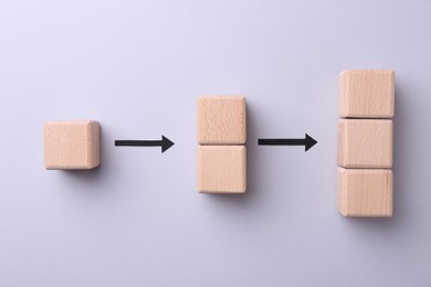 Business process organization and optimization. Scheme with wooden figures and arrows on lilac background, top view