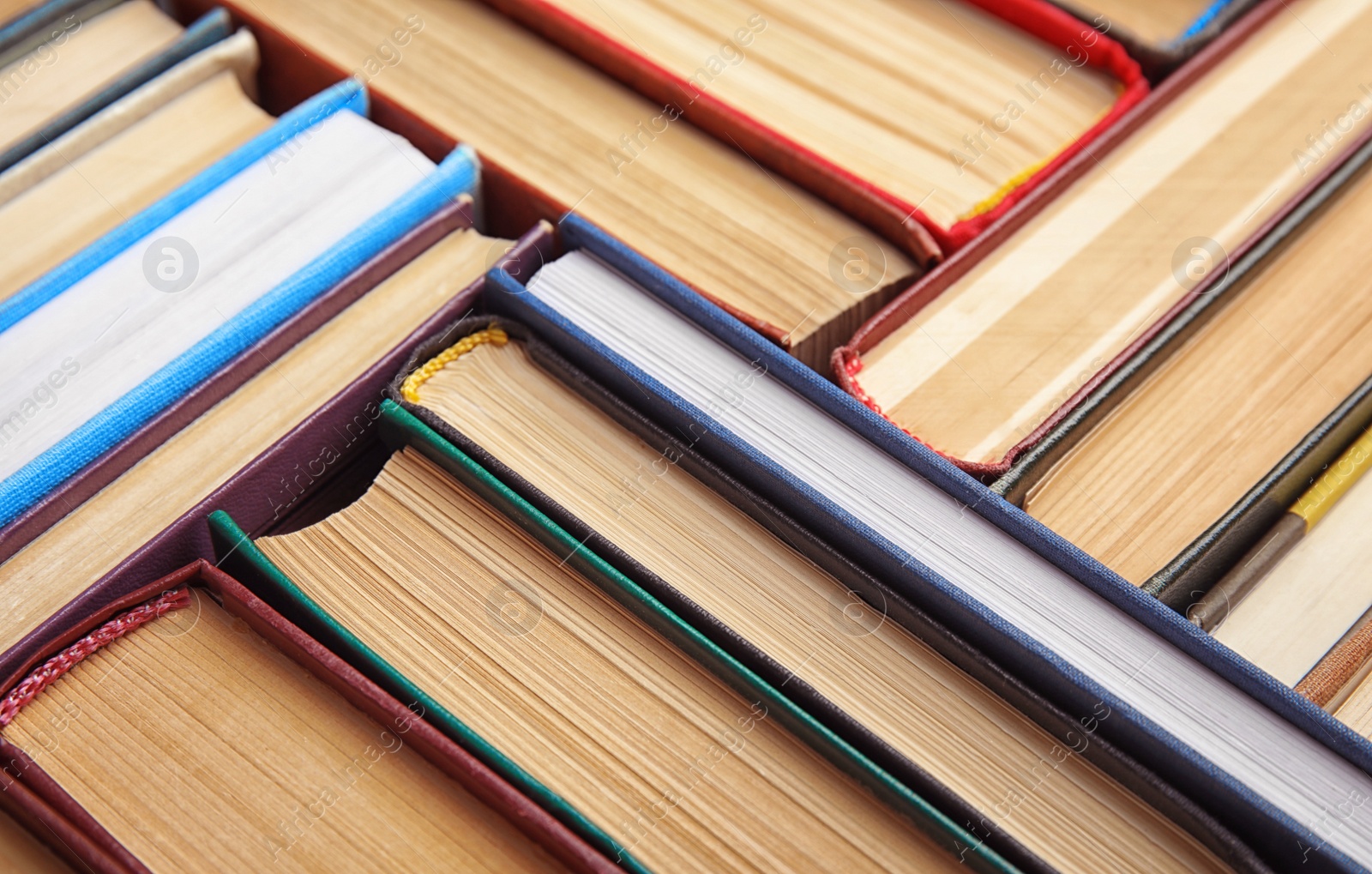 Photo of Many different hardcover books as background, closeup