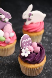 Photo of Tasty decorated Easter cupcakes on grey table