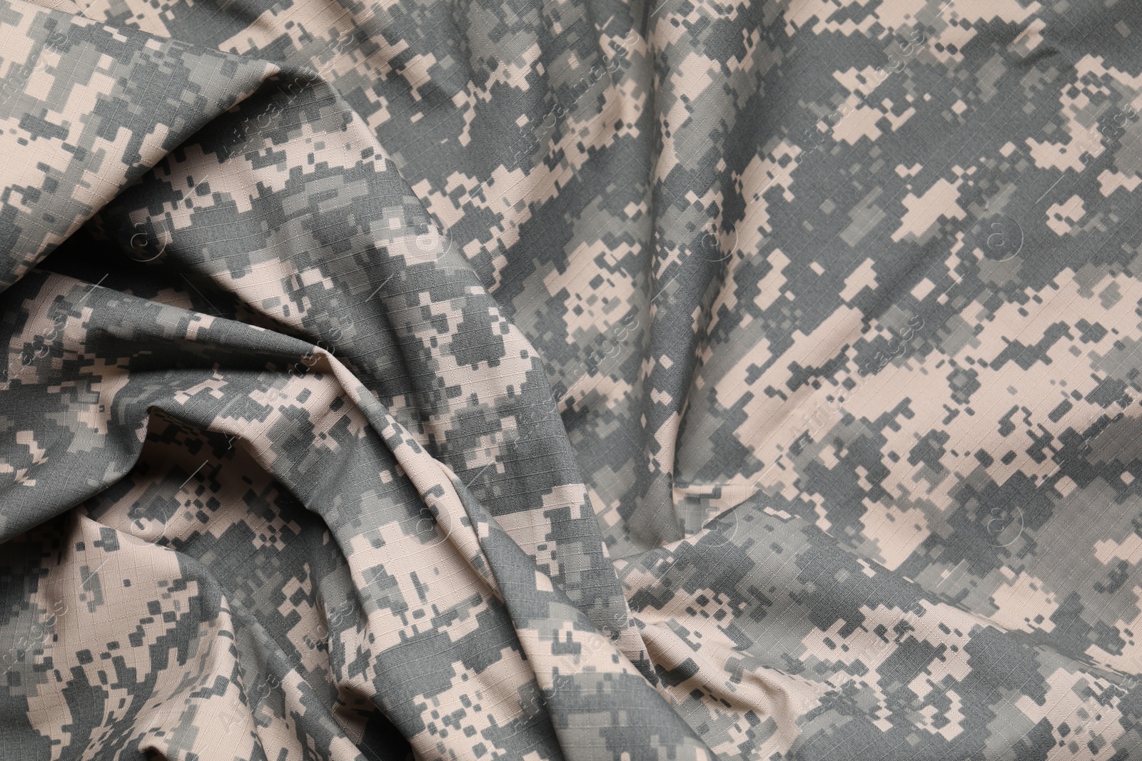 Photo of Texture of crumpled camouflage fabric as background, top view