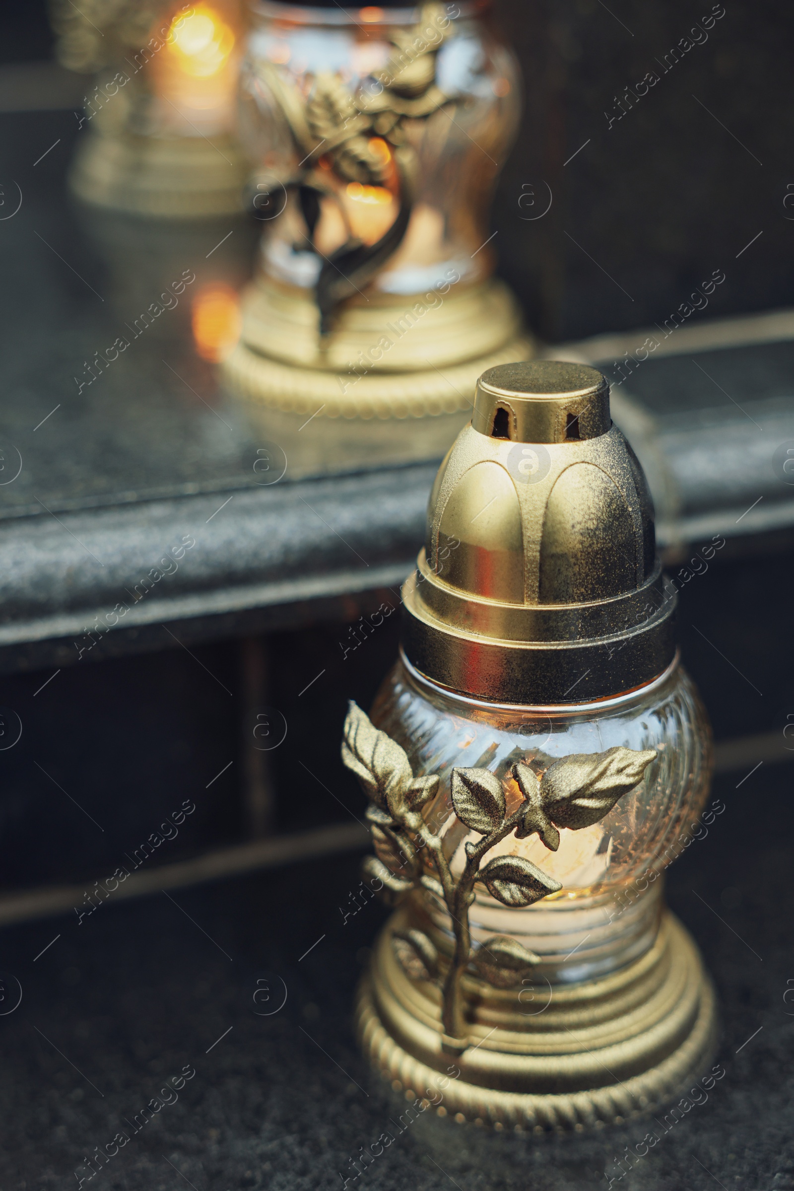 Photo of Grave lights on granite surface at cemetery